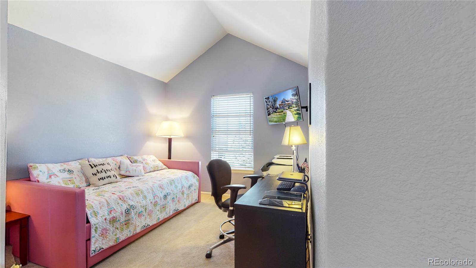 10105 North Grove Loop, Unit A Westminster, CO 80031 - Photo 17 of 40 a bedroom with a bed and a lamp next to a window