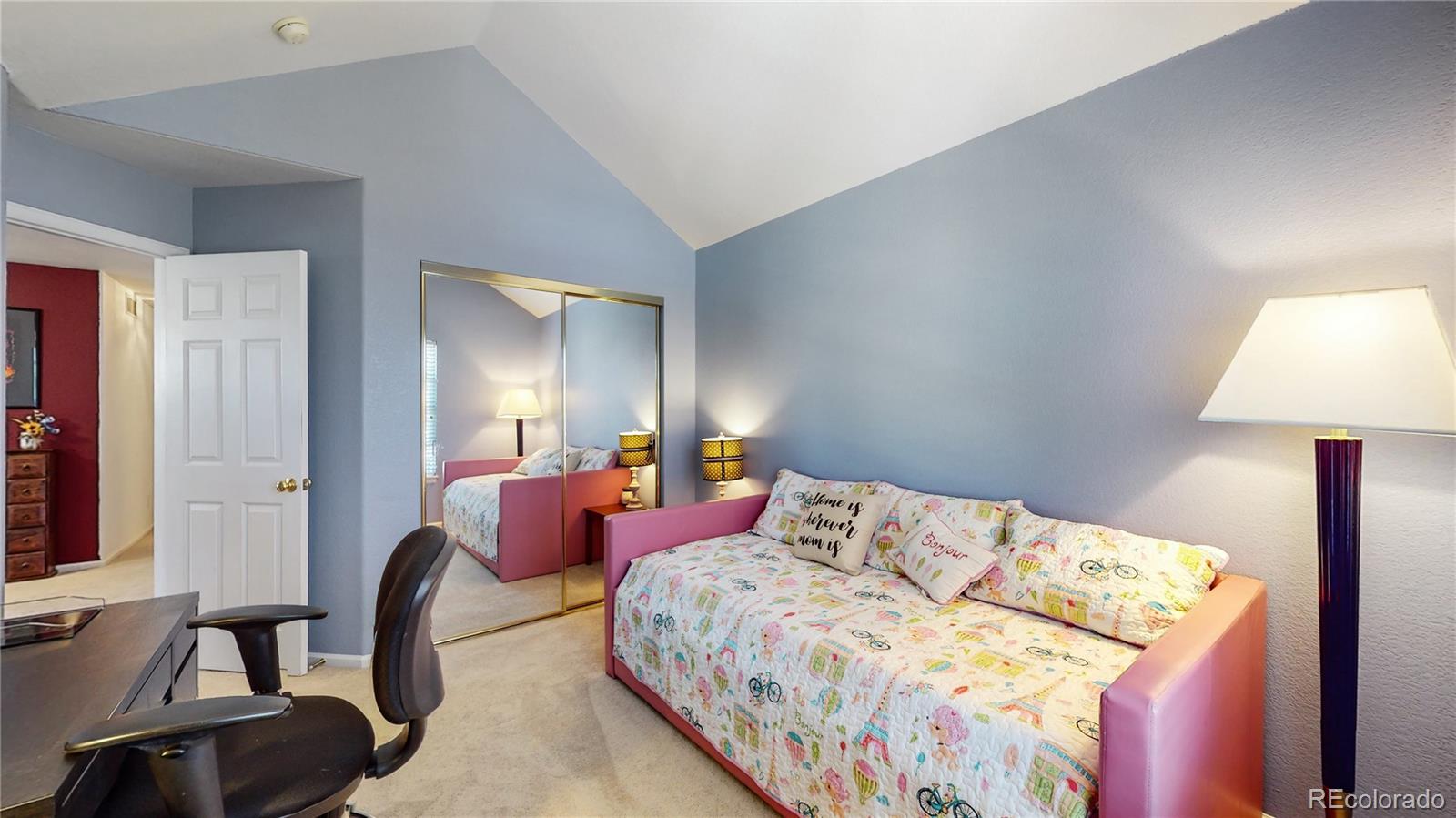 10105 North Grove Loop, Unit A Westminster, CO 80031 - Photo 18 of 40 a bedroom with a bed chair and lamp