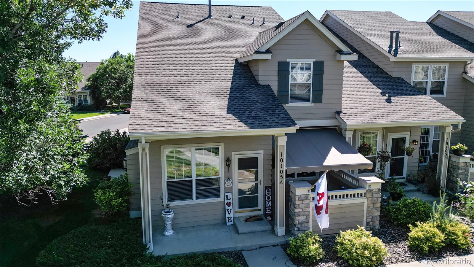 10105 North Grove Loop, Unit A Westminster, CO 80031 - Photo 3 of 40 a front view of a house with garden