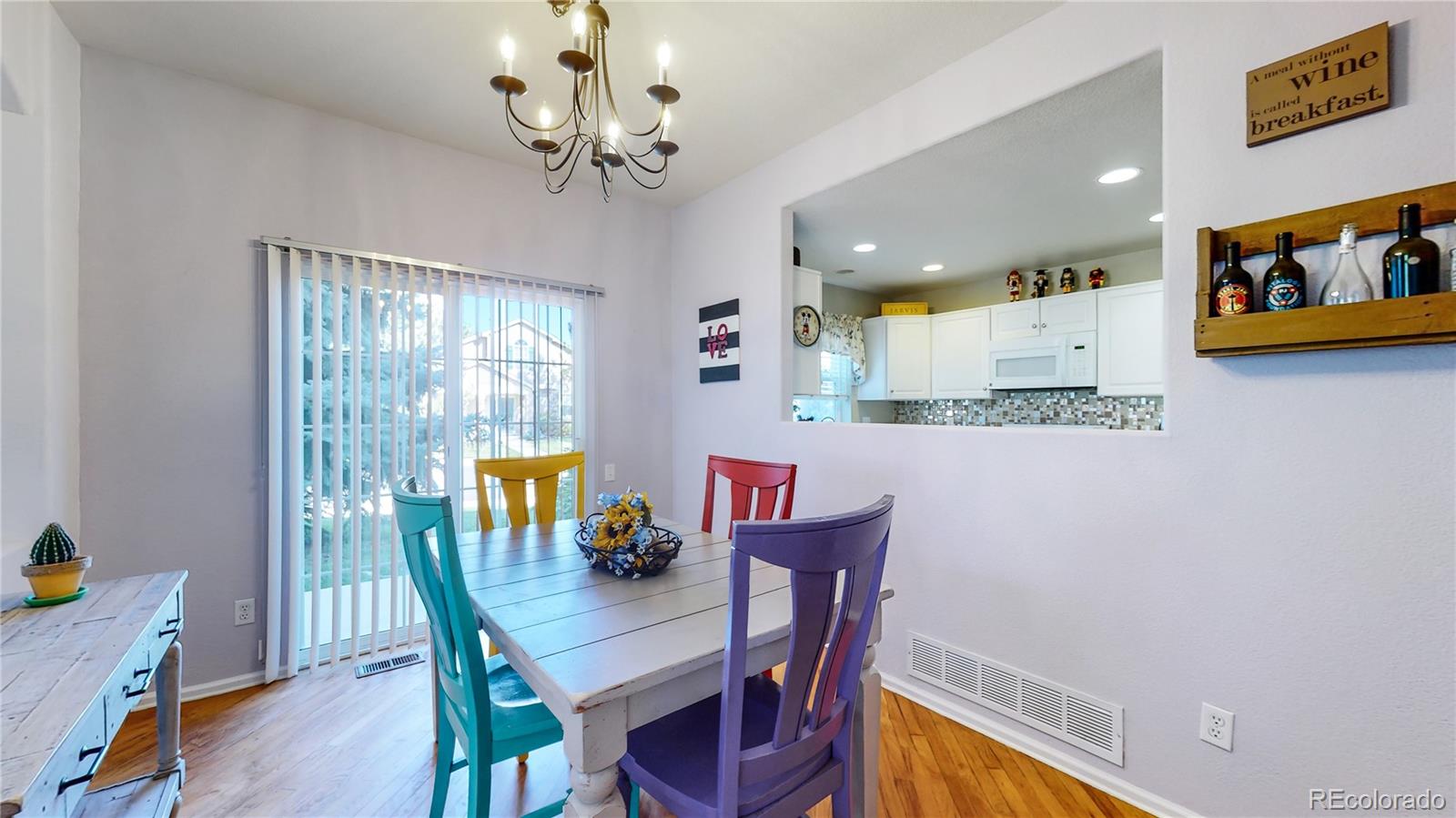 10105 North Grove Loop, Unit A Westminster, CO 80031 - Photo 7 of 40 a view of a dining room with furniture window and wooden floor
