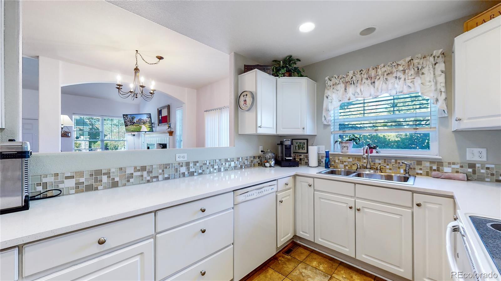 10105 North Grove Loop, Unit A Westminster, CO 80031 - Photo 10 of 40 a kitchen with a sink cabinets and window