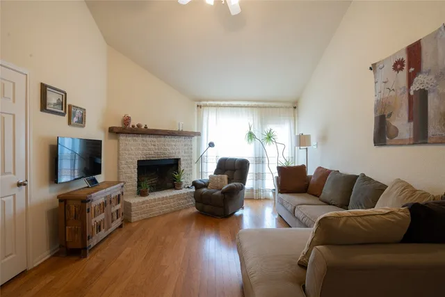 a living room with furniture flat screen tv and a fireplace