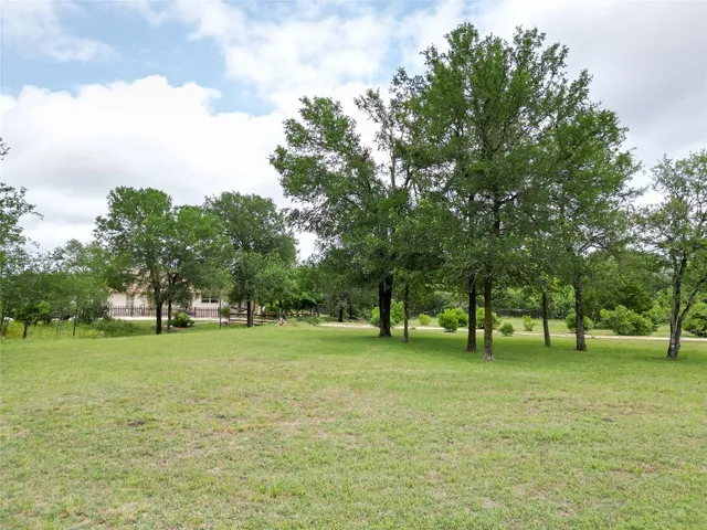 a view of field with trees in the background