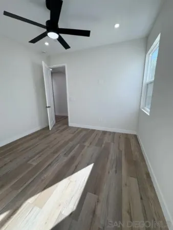a view of a hallway with a glass door and shower