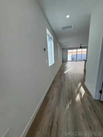 a kitchen with white cabinets and sink