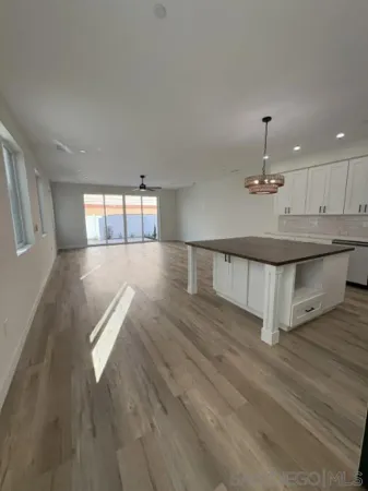 a kitchen with granite countertop white cabinets and stainless steel appliances