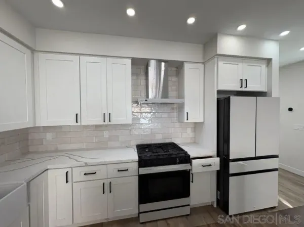 a large kitchen with a table and chairs in it