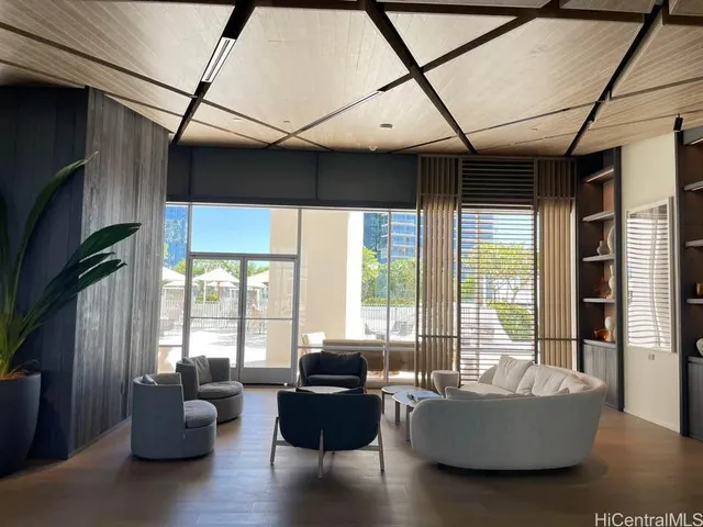 a living room with furniture and floor to ceiling windows