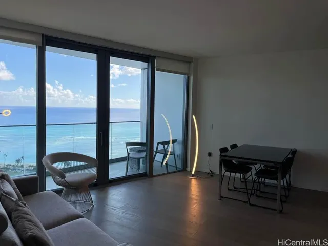 a living room with furniture and a floor to ceiling window