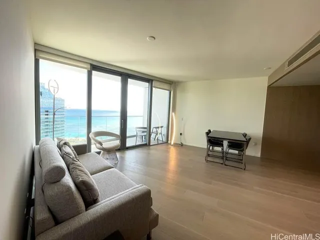 a living room with furniture and a floor to ceiling window