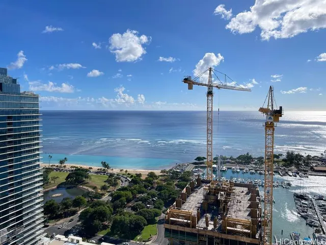 a view of a room with a floor to ceiling window and outdoor kitchen