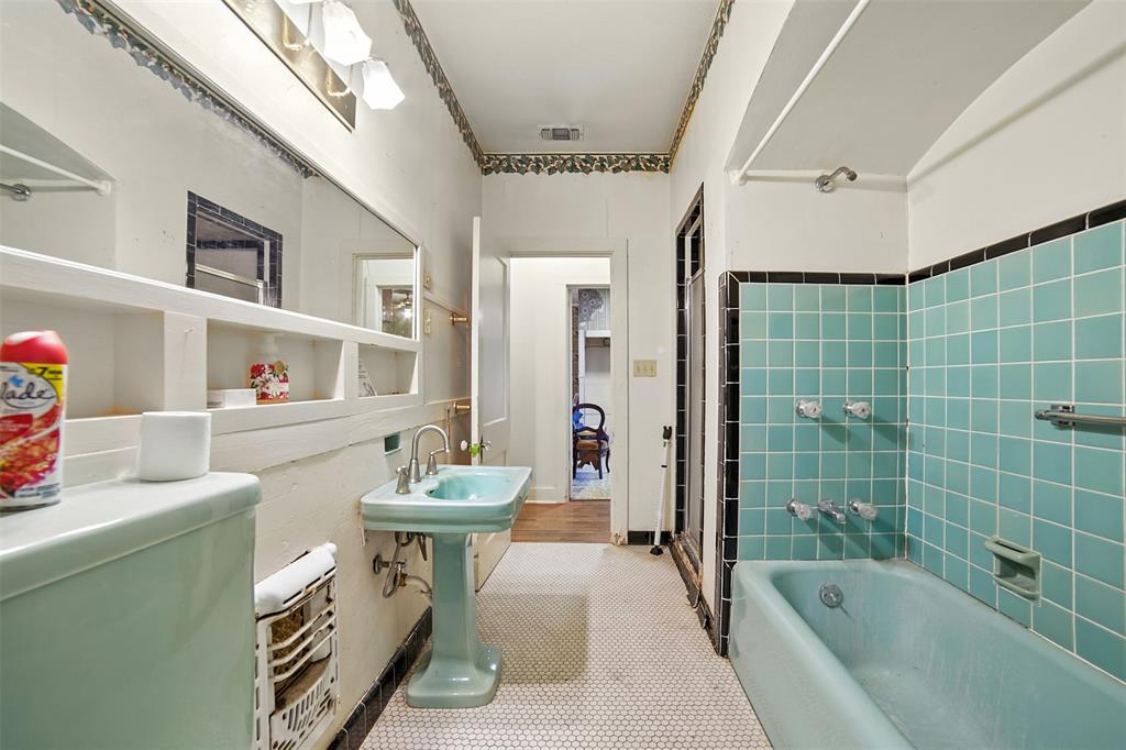 514 South Main Street Lockhart, TX 78644 - Photo 13 of 14 a bathroom with a sink a bathtub and a shower