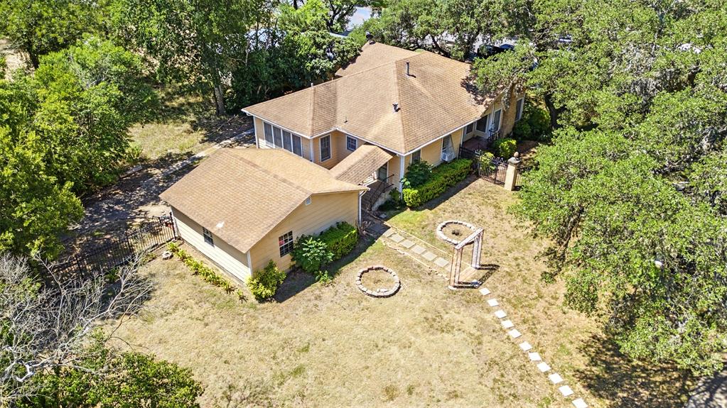 514 South Main Street Lockhart, TX 78644 - Photo 2 of 14 an aerial view of a house with swimming pool and large trees