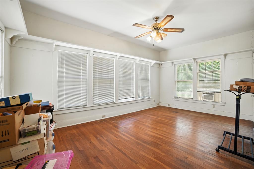 514 South Main Street Lockhart, TX 78644 - Photo 5 of 14 a view of livingroom with hardwood floor and a ceiling fan