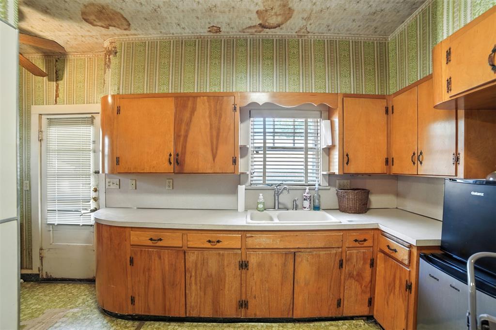 514 South Main Street Lockhart, TX 78644 - Photo 10 of 14 a bathroom with a sink a mirror and shower