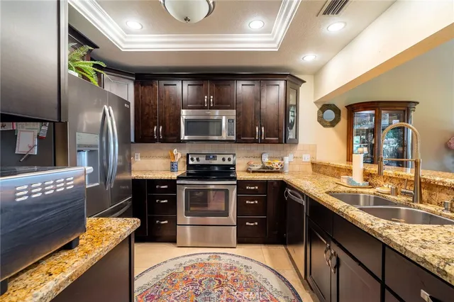 a kitchen with a refrigerator stove and microwave