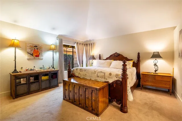 a bed sitting in a bedroom next to a book shelf