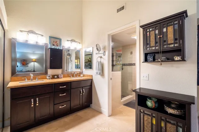 a bathroom with a shower and a sink a mirror