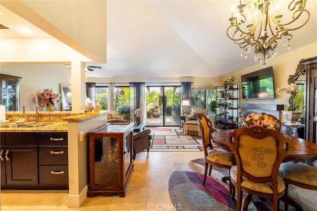 a living room with furniture fireplace and large windows
