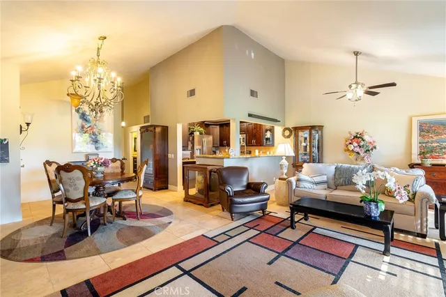 a living room with furniture a rug and a chandelier