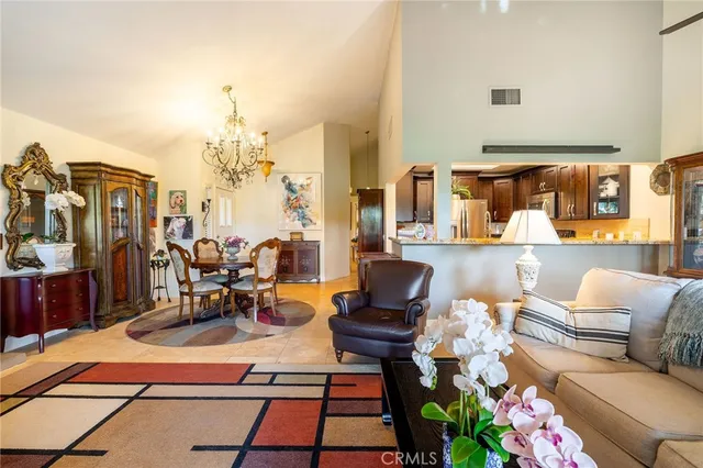 a living room with patio furniture and a flat screen tv