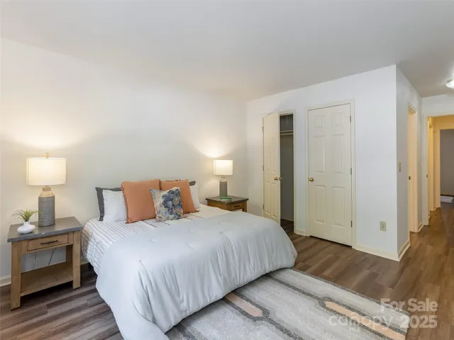 a bedroom with a bed and a lamp