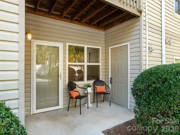 a view of a porch with chairs and a potted plant