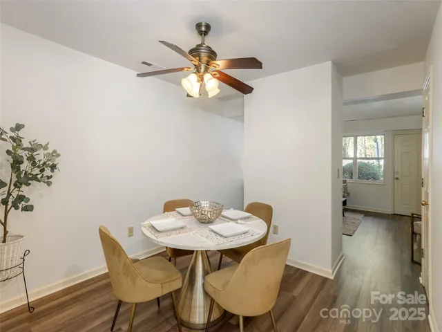 a view of a dining room with furniture and wooden floor