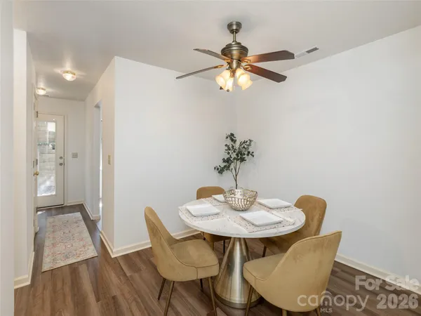a dining room with furniture and window
