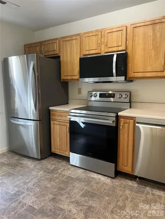 a kitchen with a stove microwave and refrigerator