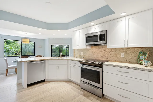 a kitchen with a stove microwave and cabinets