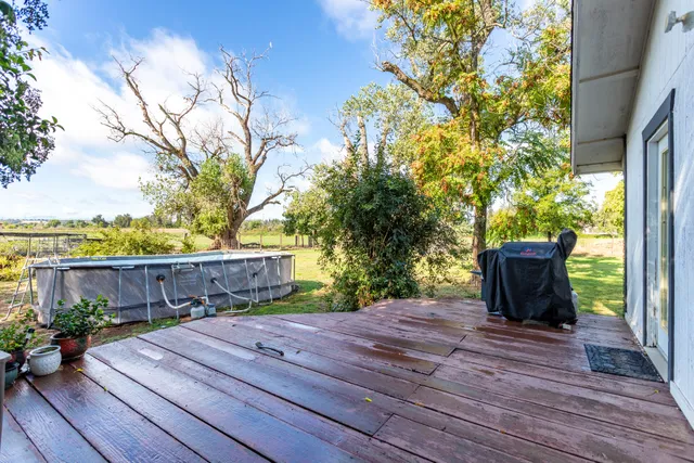 a view of a terrace with wooden floor and fence