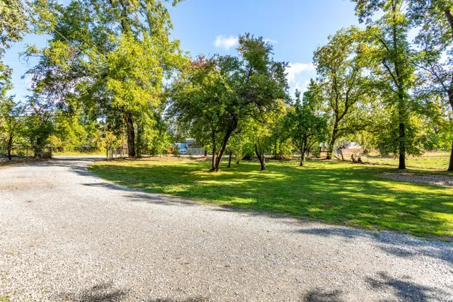 a view of a house ground with a big yard