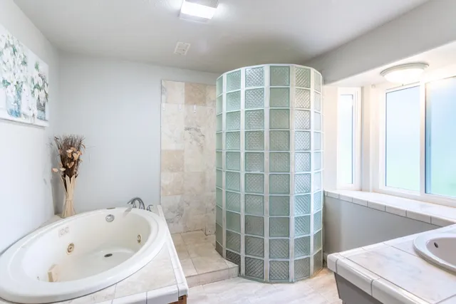 a bathroom with a bathtub and a window