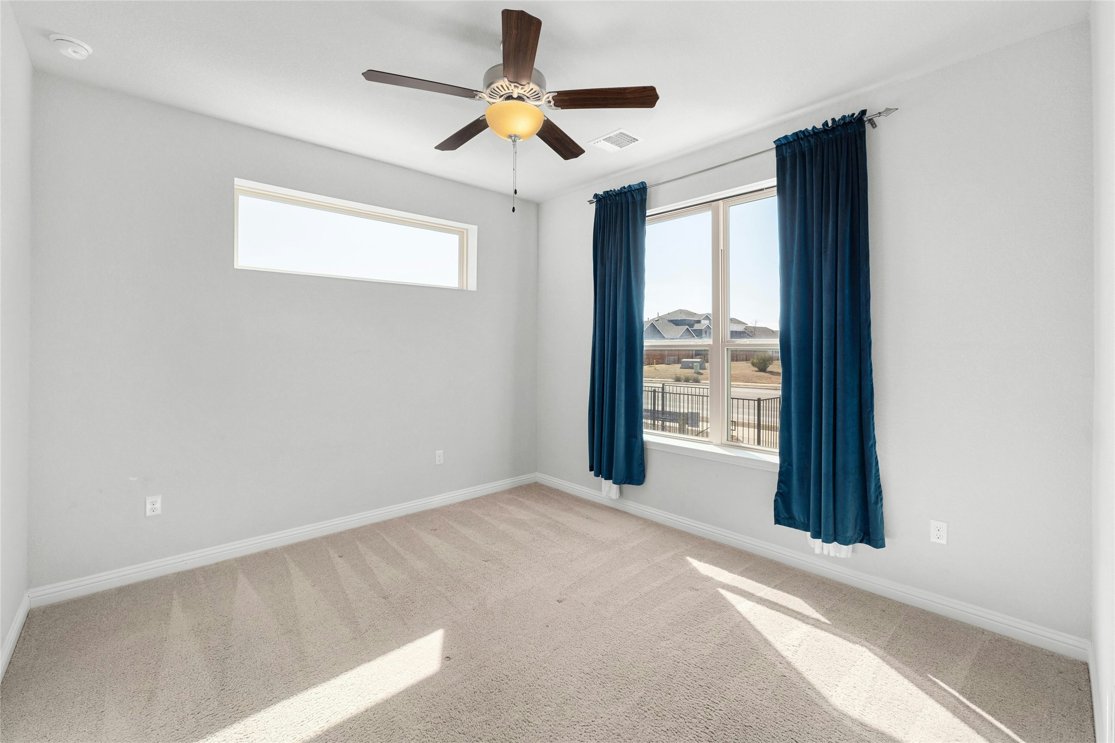 8101 Frida Bend Austin, TX 78744 - Photo 14 of 30 Unfurnished room with ceiling fan and light colored carpet