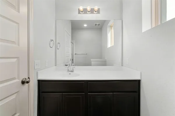 a bathroom with a sink vanity and a mirror