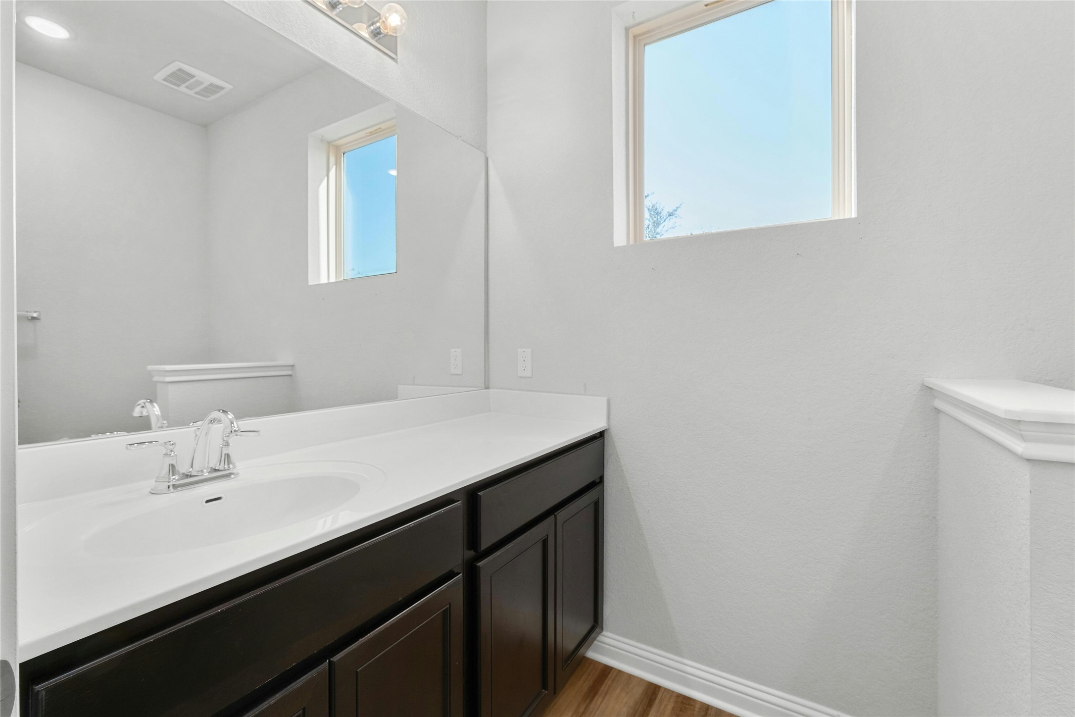 8101 Frida Bend Austin, TX 78744 - Photo 16 of 30 Bathroom with vanity and light wood-style floors