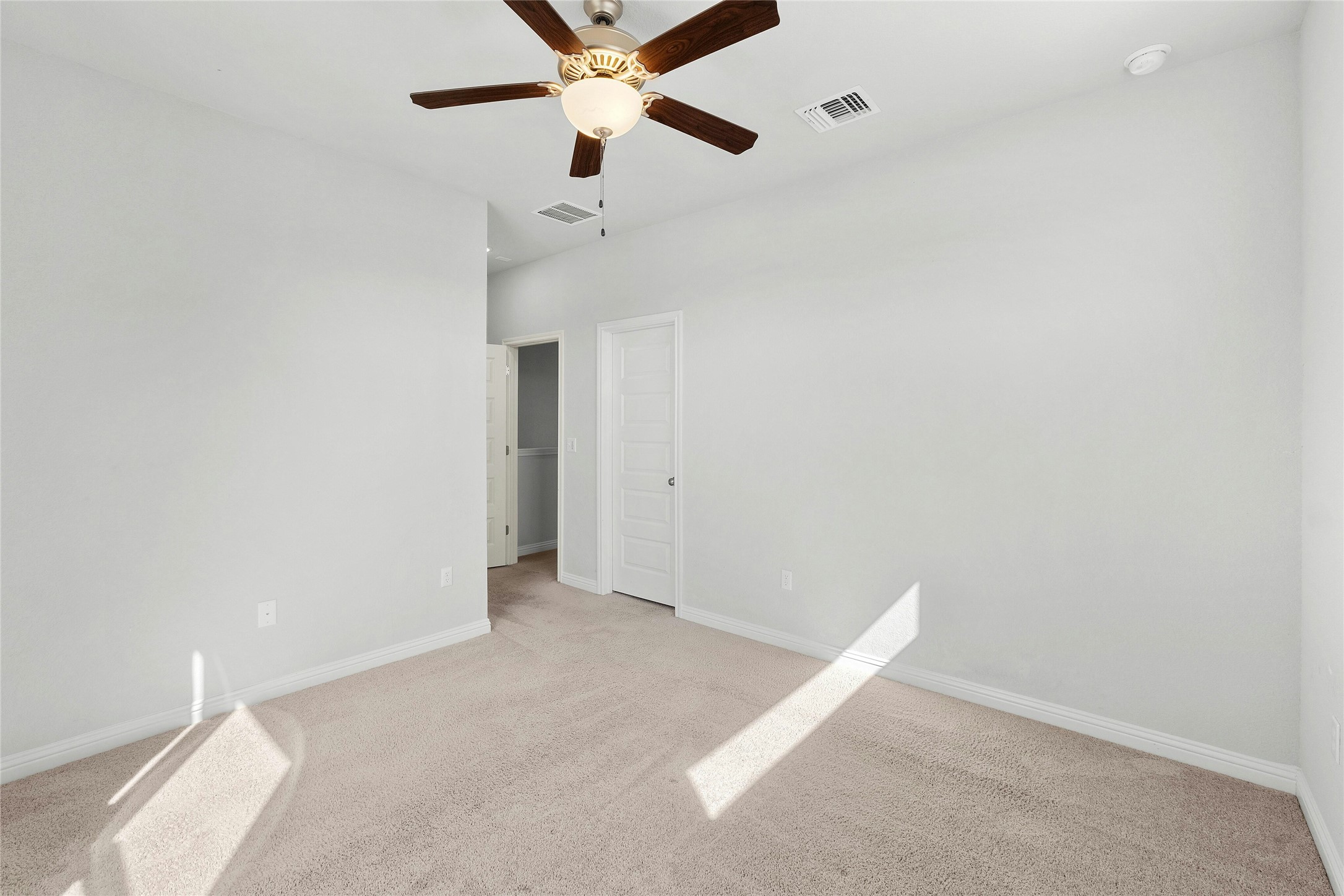 8101 Frida Bend Austin, TX 78744 - Photo 19 of 30 Unfurnished bedroom featuring light colored carpet and a ceiling fan