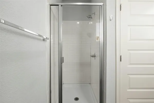 a bathroom with a glass shower door