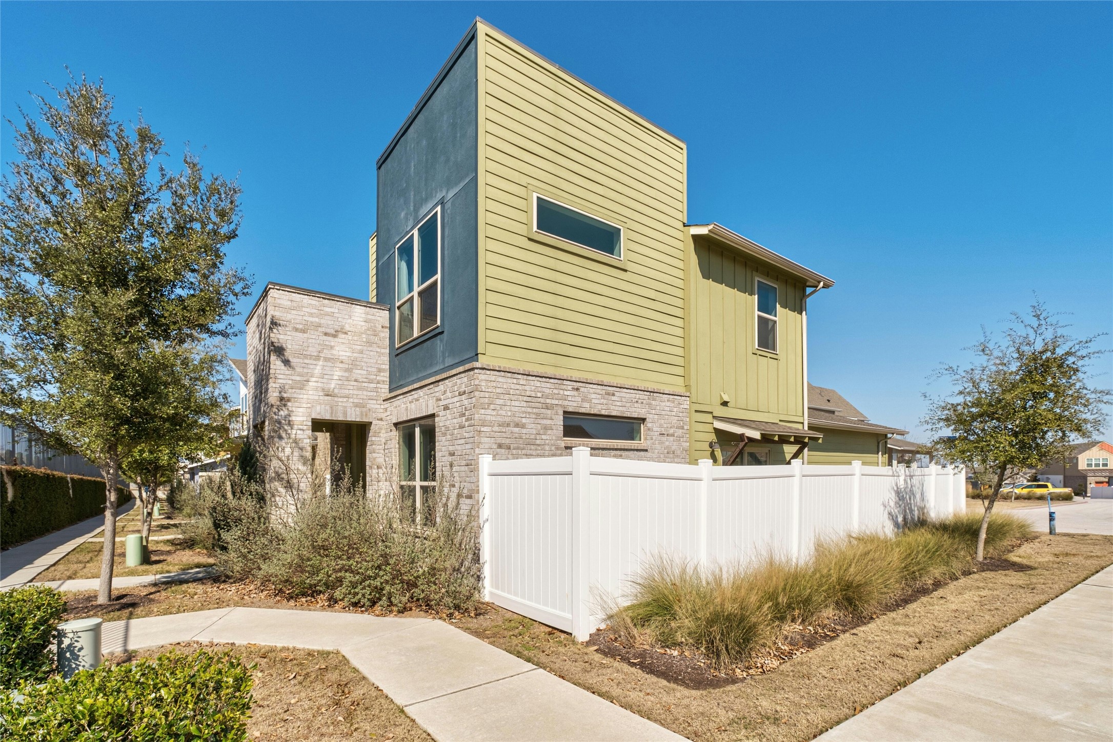 8101 Frida Bend Austin, TX 78744 - Photo 4 of 30 View of side of home featuring brick siding and board and batten siding