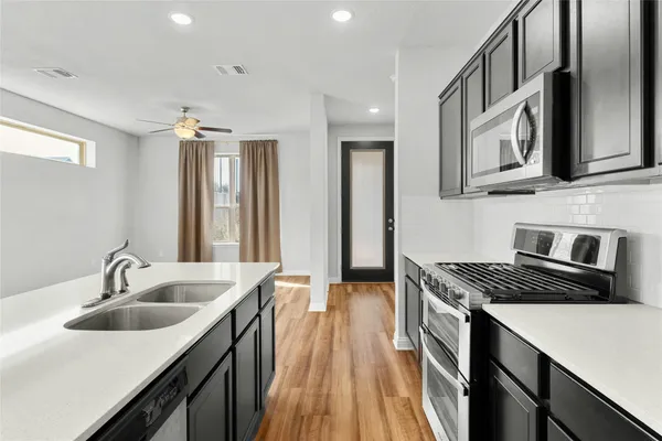 a kitchen that has a sink and a stove