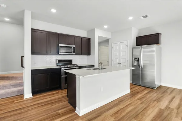 a kitchen with a refrigerator stove and microwave