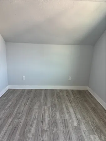 a view of an empty room and wooden floor