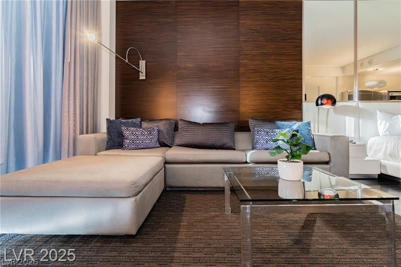 4381 West Flamingo Road, Unit 1809 Las Vegas, NV 89103 - Photo 2 of 11 Living room featuring wooden walls