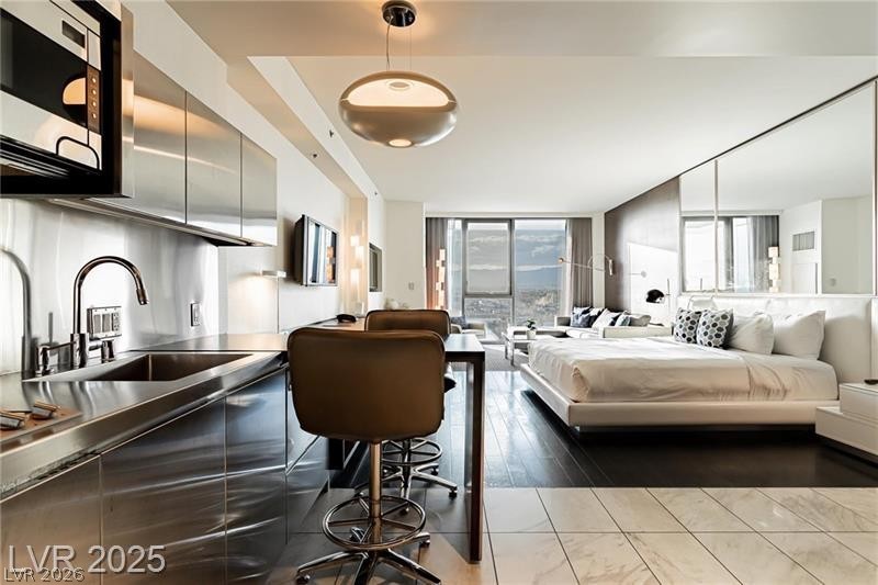 4381 West Flamingo Road, Unit 1809 Las Vegas, NV 89103 - Photo 4 of 11 Bedroom with access to exterior, floor to ceiling windows, and light wood finished floors