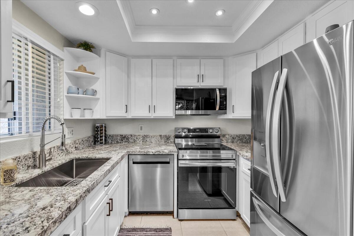 2700 Lawrence Crossley Road, Unit 83 Palm Springs, CA 92264 - Photo 11 of 52 a kitchen with a sink stove and refrigerator