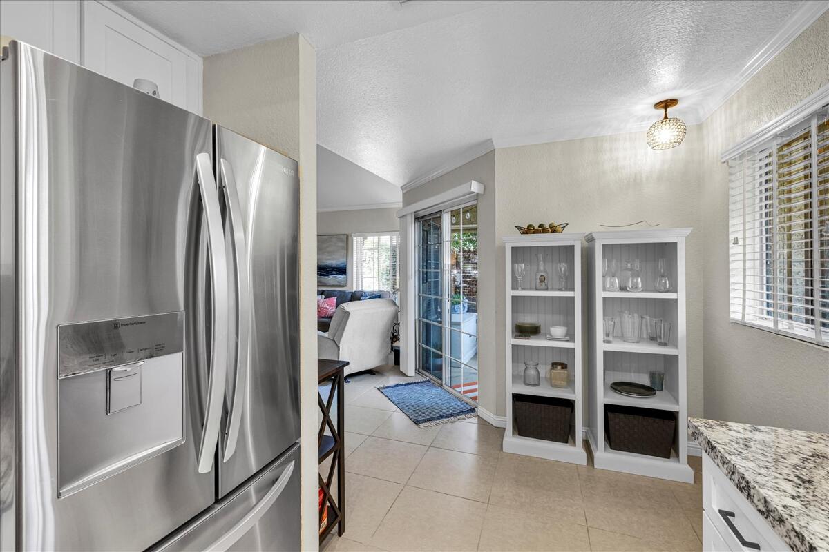 2700 Lawrence Crossley Road, Unit 83 Palm Springs, CA 92264 - Photo 14 of 52 a kitchen with refrigerator and cabinets