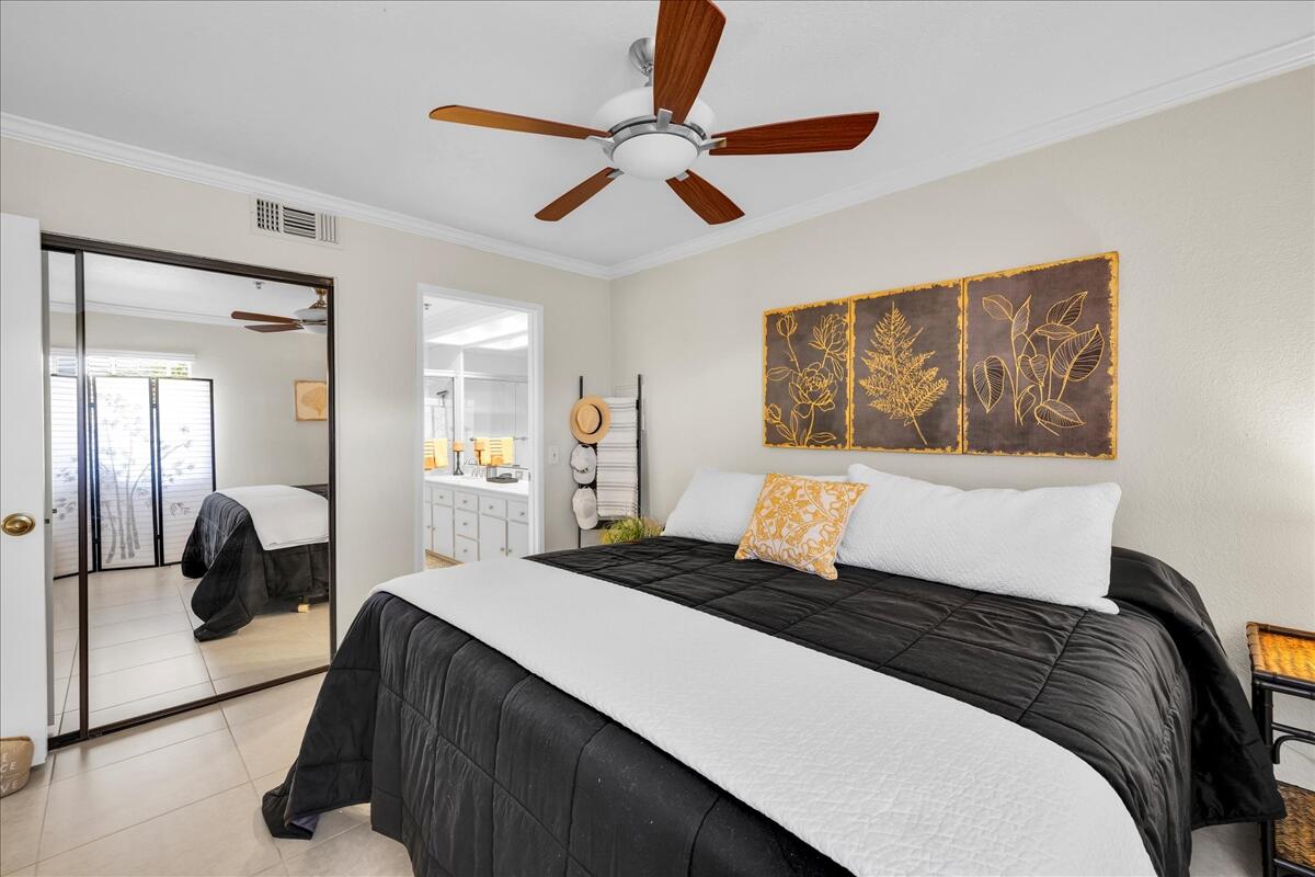 2700 Lawrence Crossley Road, Unit 83 Palm Springs, CA 92264 - Photo 17 of 52 a bedroom with a bed and a painting on the wall