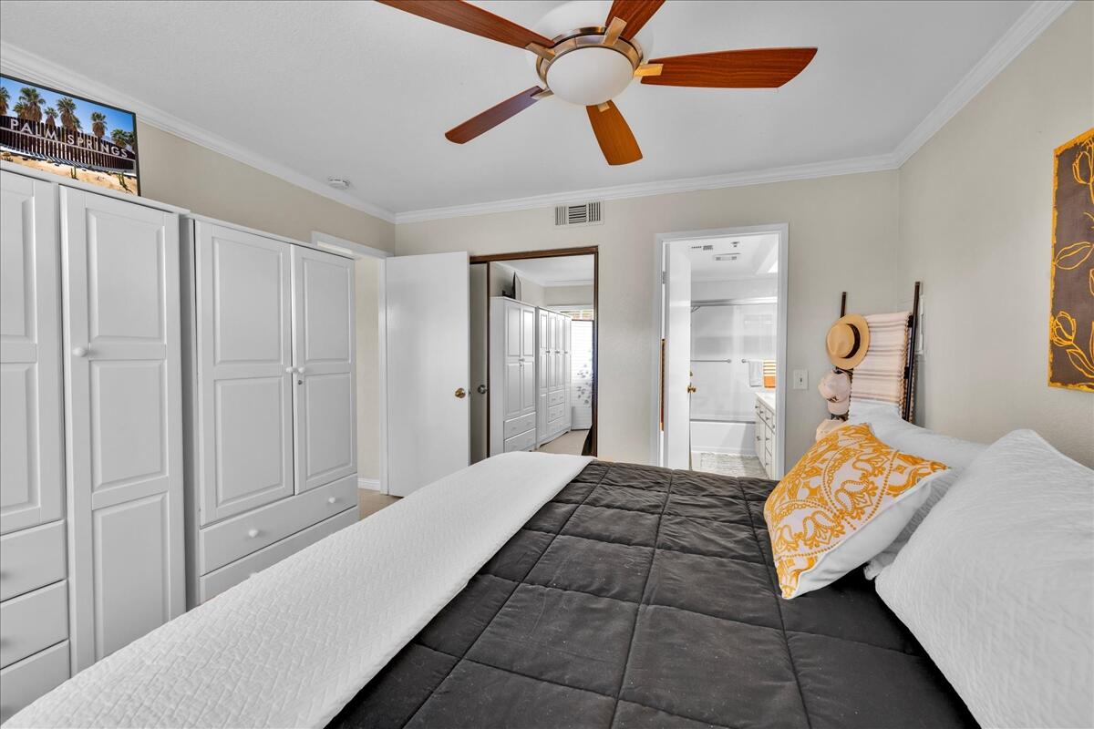 2700 Lawrence Crossley Road, Unit 83 Palm Springs, CA 92264 - Photo 20 of 52 a bedroom with a bed and painting on the wall