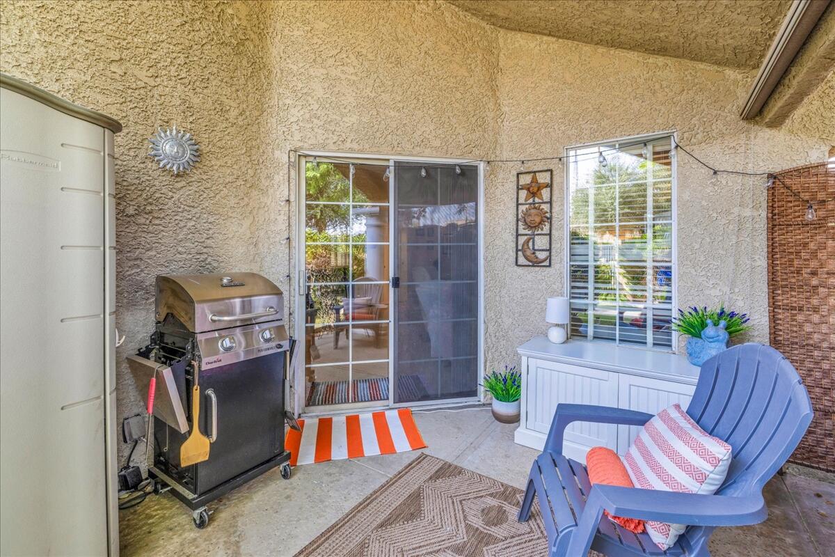 2700 Lawrence Crossley Road, Unit 83 Palm Springs, CA 92264 - Photo 26 of 52 a living room with furniture a flat screen tv and a window